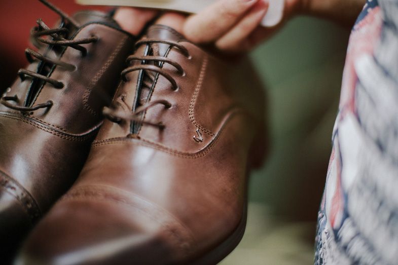 Close-up detail of brown leather oxford dress shoes with laces.