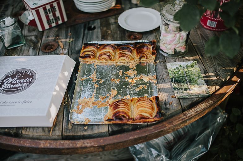 Freshly baked pastries displayed on vintage baking sheets at a rustic wedding dessert table.