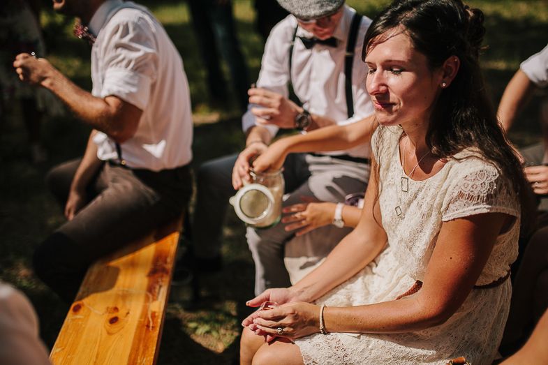 A guest enjoying refreshments at a casual outdoor wedding reception.