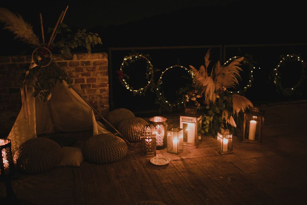 Romantic candlelit setting with dreamcatchers and fairy lights creating ambient atmosphere.