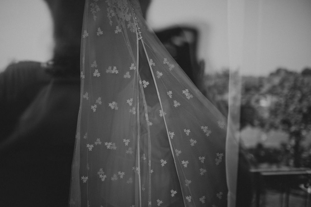 Black and white shot of delicate patterned fabric with small floral designs.