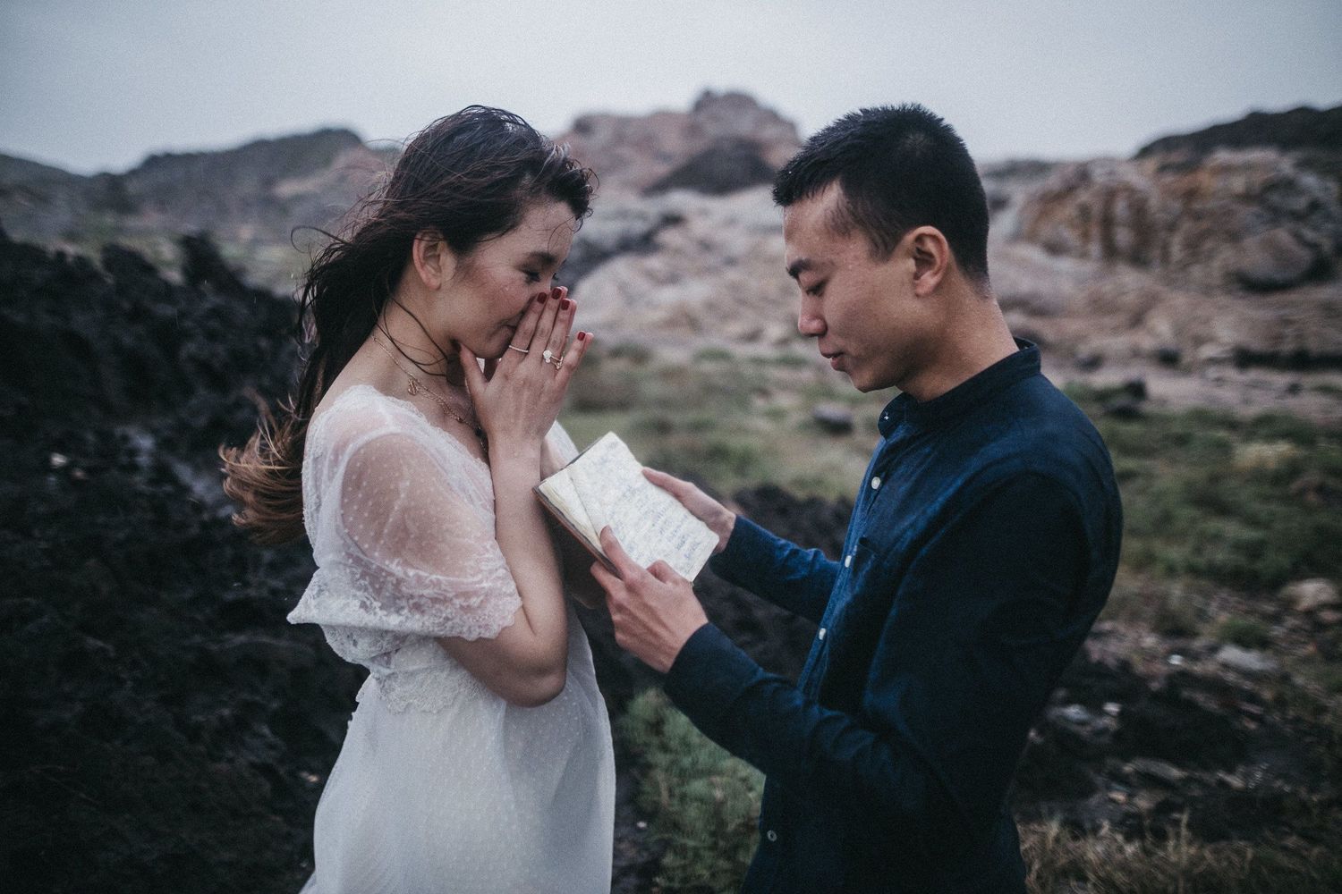 A romantic proposal scene unfolds in front of dramatic mountain scenery.