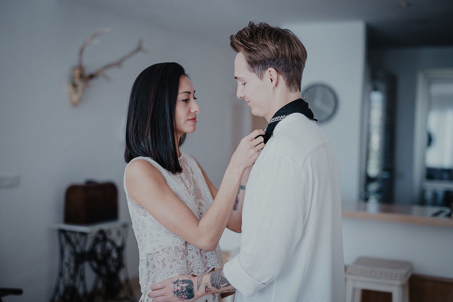 A romantic couple sharing an intimate moment in a minimalist interior setting.