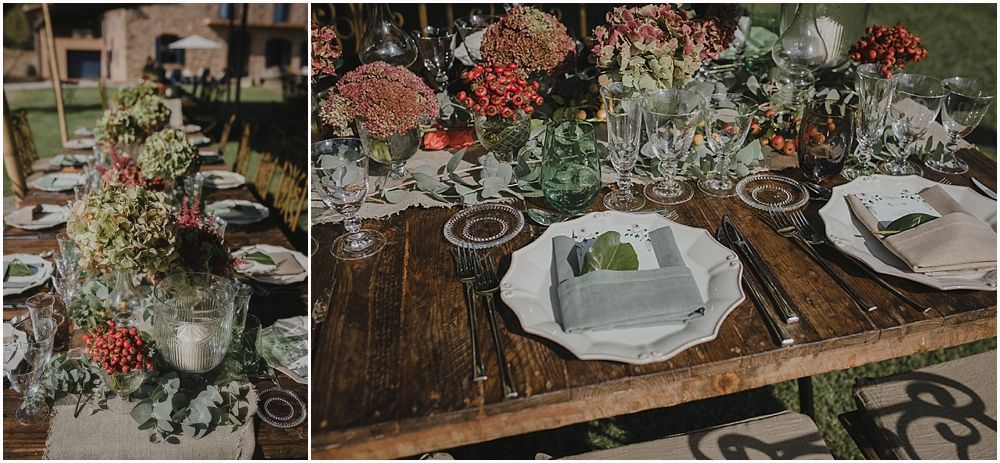 Rustic wedding table setting with vintage decor and floral arrangements on wooden tables.