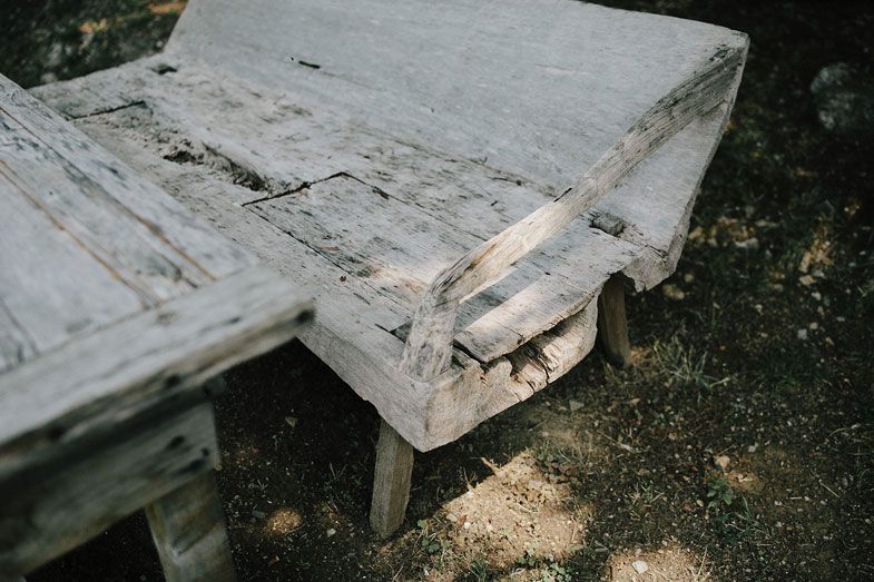 Weathered white wooden bench showing signs of age and wear.