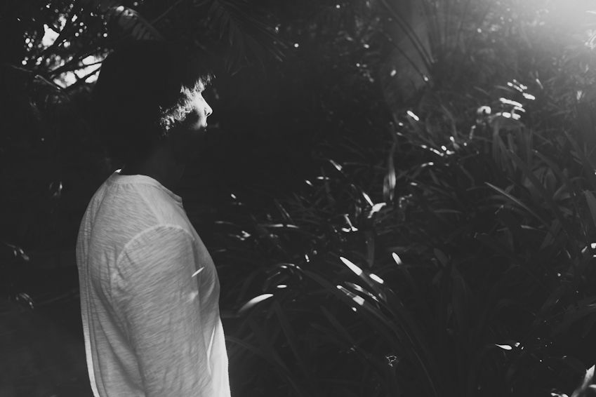 An artistic black and white photo showing a person's shoulder in dramatic lighting.