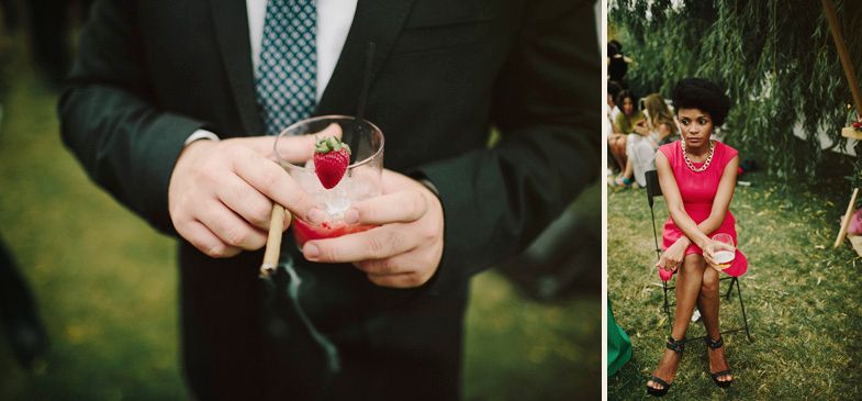 Wedding guest holds a heart-shaped accessory at an outdoor celebration.