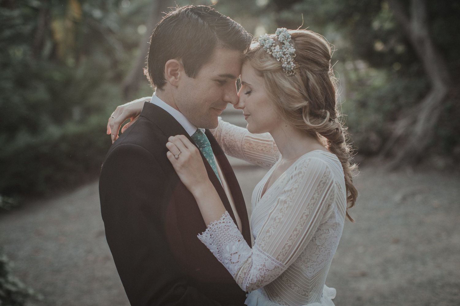 Intimate winter wedding portrait of newlyweds embracing in soft, romantic lighting.