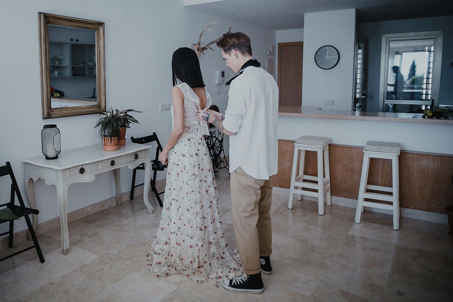 Couple standing together in a modern home interior with minimal decor.