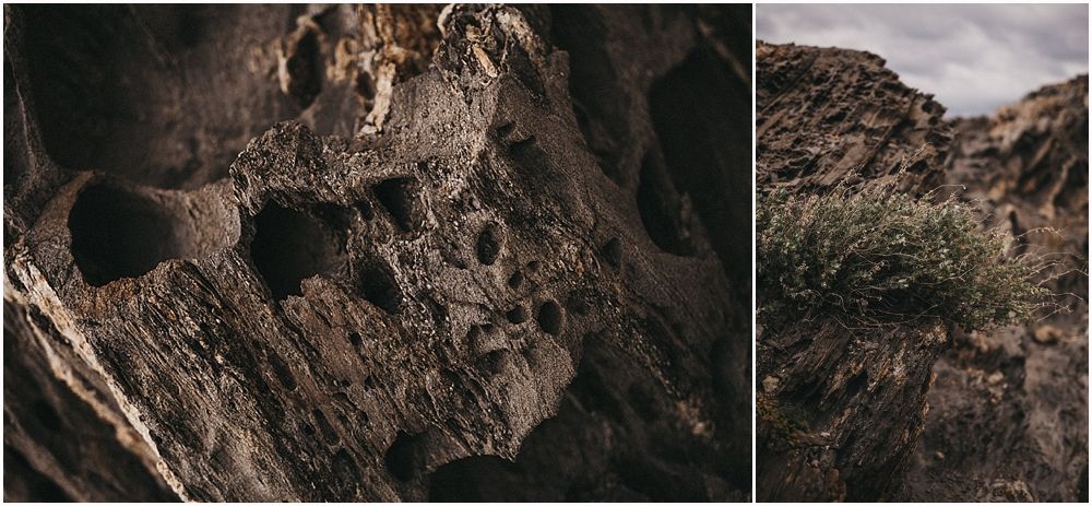Close-up of textured rock formations alongside a mountainous desert landscape.