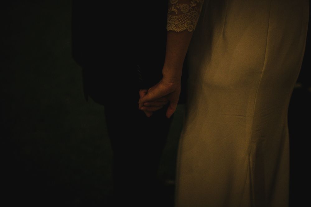 A close-up detail shot of formal attire in dim lighting at an evening event.