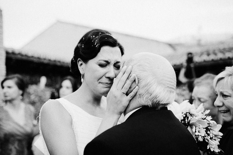 An emotional black and white moment during a wedding celebration.
