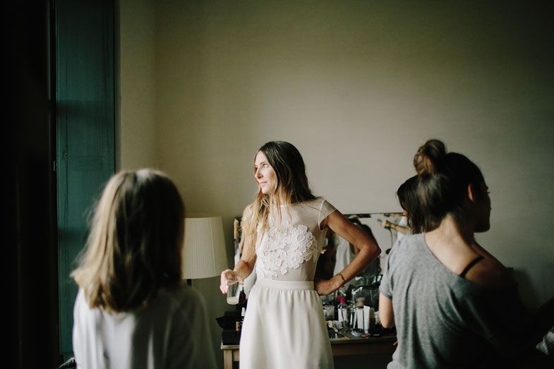 Group gathering in room with natural light during wedding preparations.