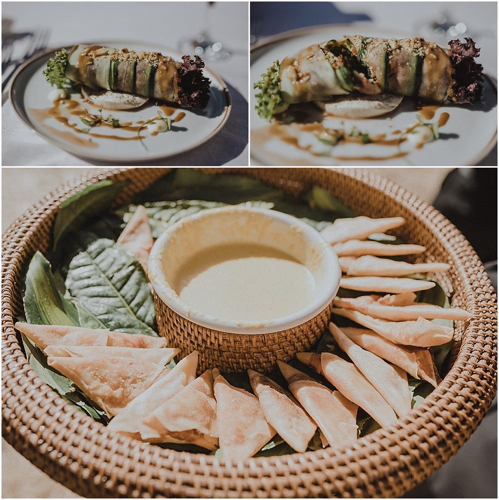 Elegantly plated appetizers and dips served on woven rattan tray at catered event.