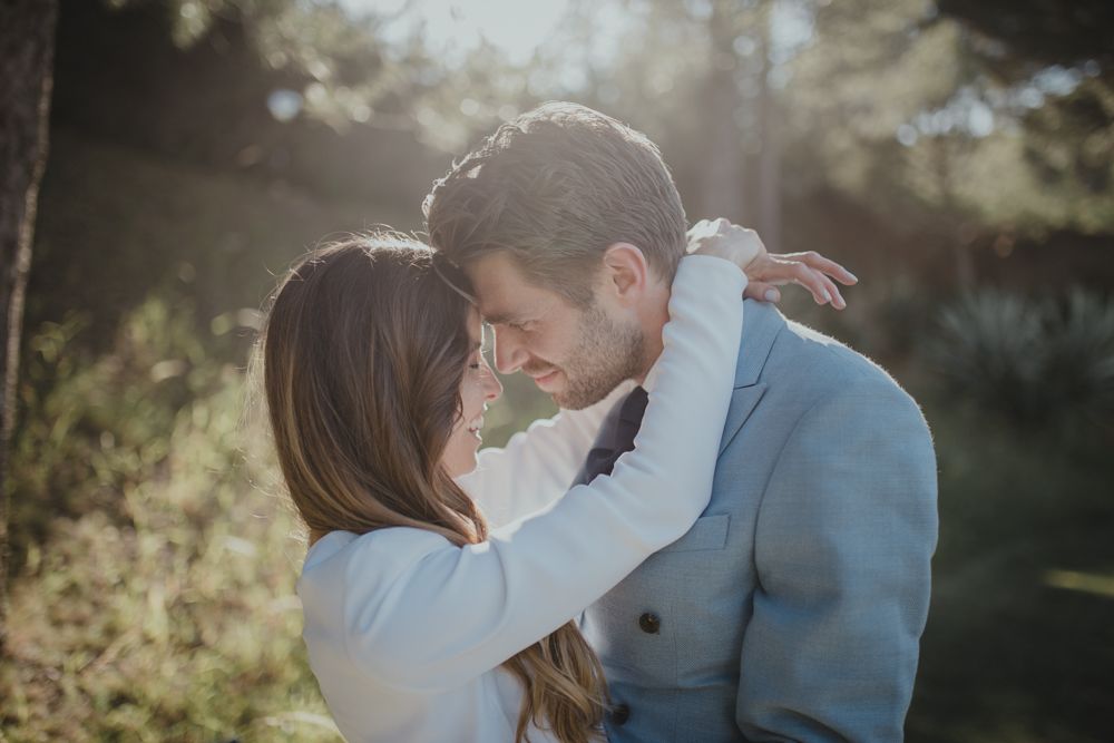 Romantic close-up moment between couple in formal wear during outdoor photo session.