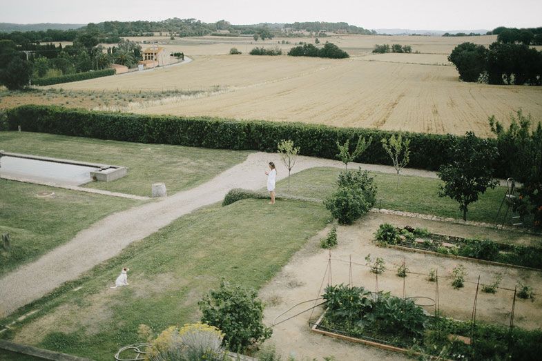 Aerial view of a rural landscape with paths, fields and scattered buildings.