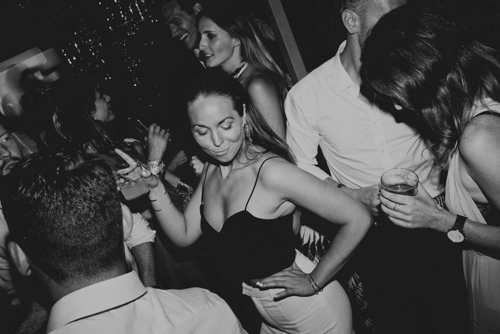 People dancing and celebrating at a lively nighttime party.