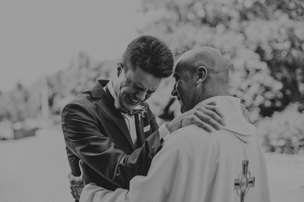 Black and white emotional moment shared between two people during a wedding ceremony.