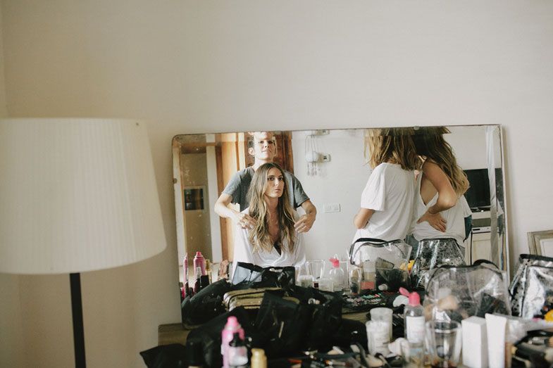 Interior scene with vanity mirror and beauty preparation items.