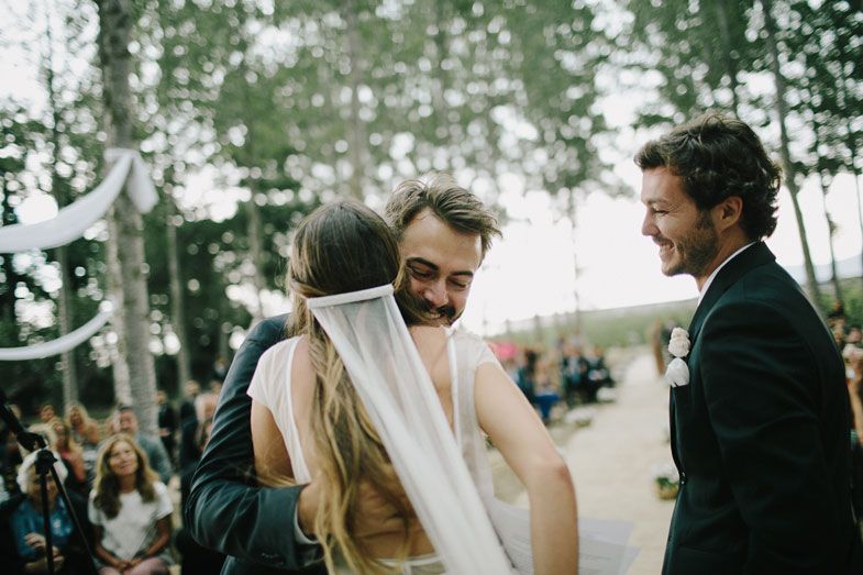 Candid celebration moment during an outdoor wedding in a scenic aspen grove.