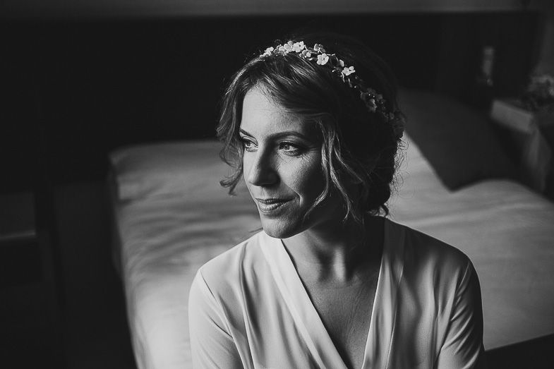 Elegant black and white portrait in morning light with soft shadows.