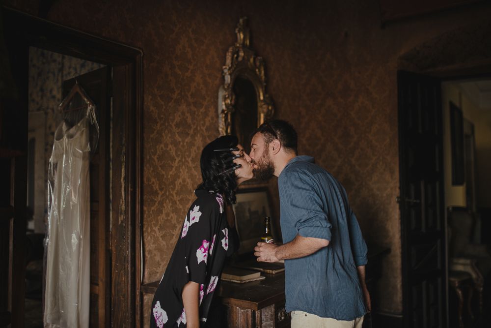 Atmospheric portrait in a dimly lit vintage room with window light.