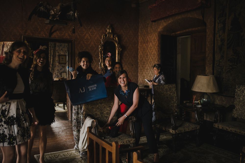 Behind-the-scenes shot of wedding preparations in a dimly lit vintage room.