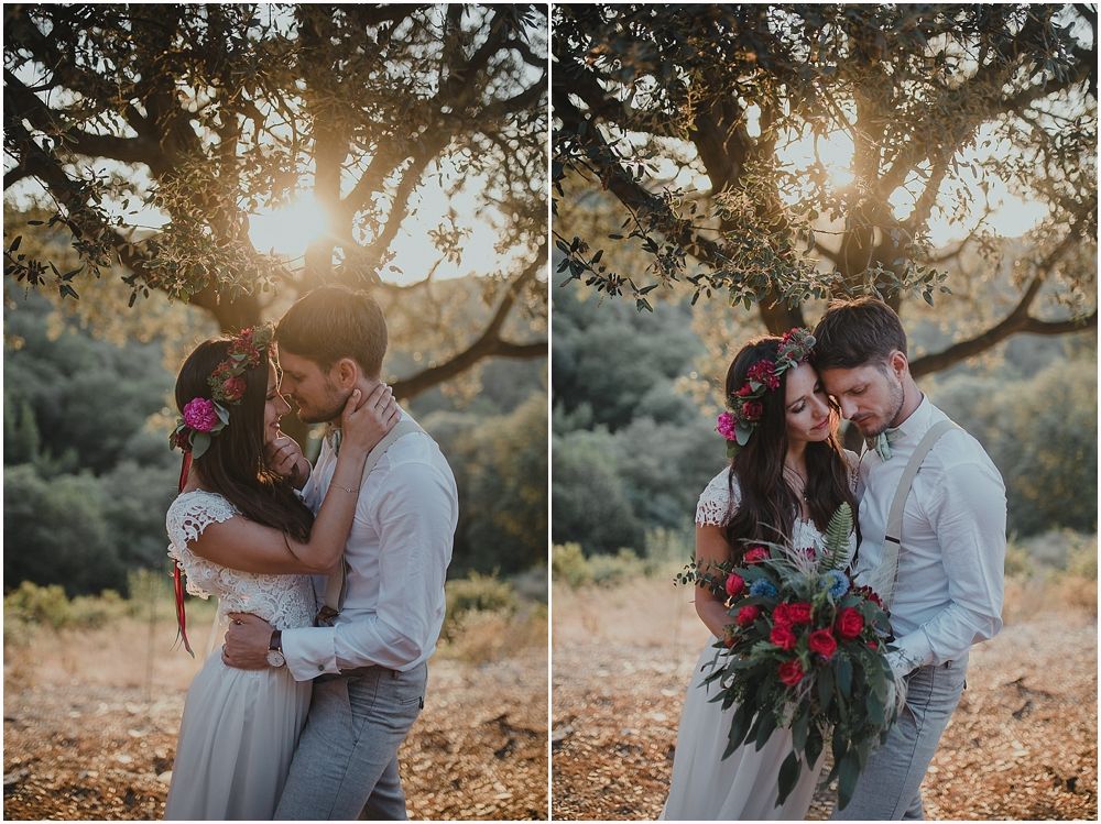 Romantic sunset wedding photoshoot with couple embracing under tree branches.