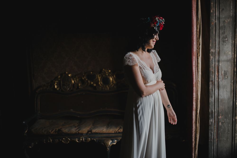 A romantic bridal photo in a vintage setting with ornate furniture and natural window light.