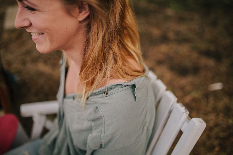 Candid moment captured during an outdoor makeup session showing a genuine smile.