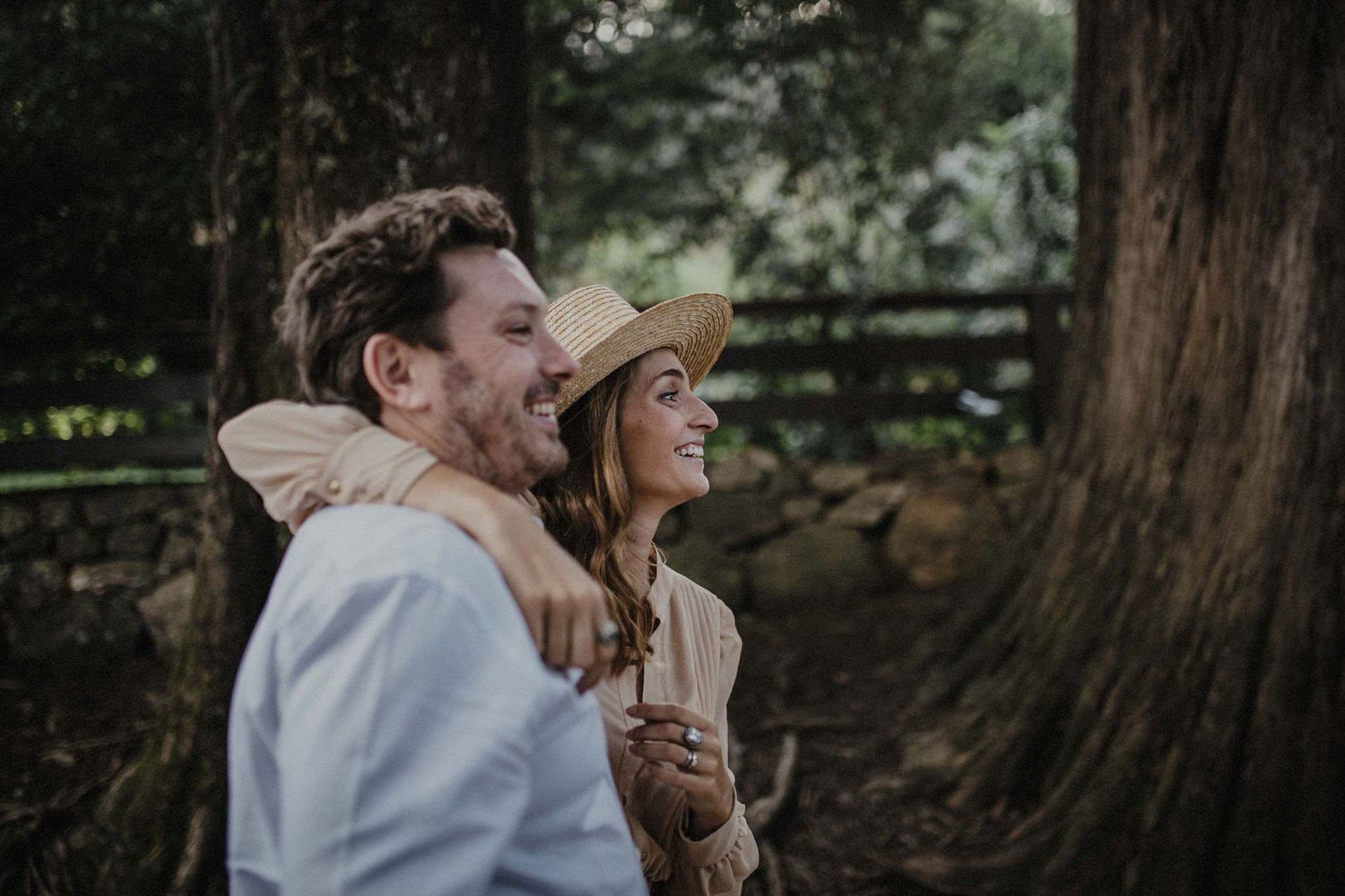 A candid moment of laughter and joy captured in a wooded setting.