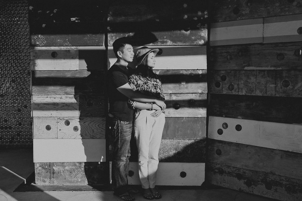 A black and white artistic moment captured against rustic wooden panels.