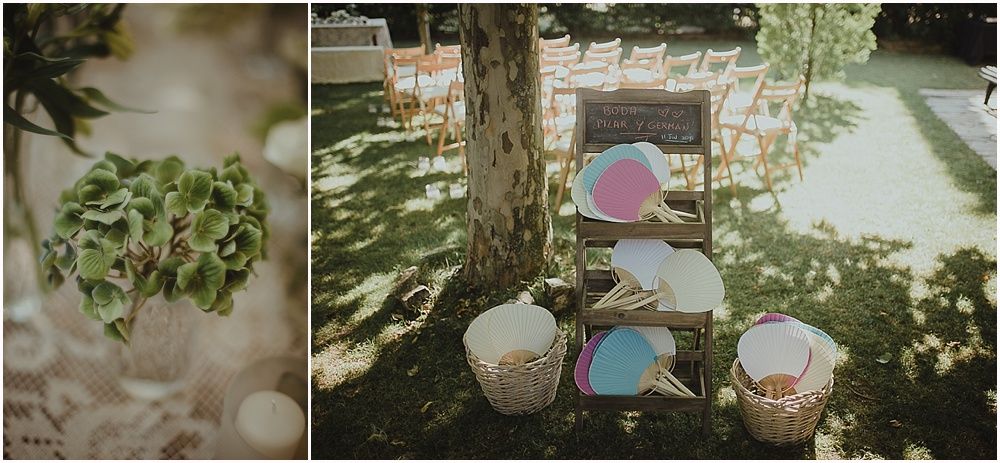 Outdoor wedding decorations with hanging lanterns and baskets in a garden setting.