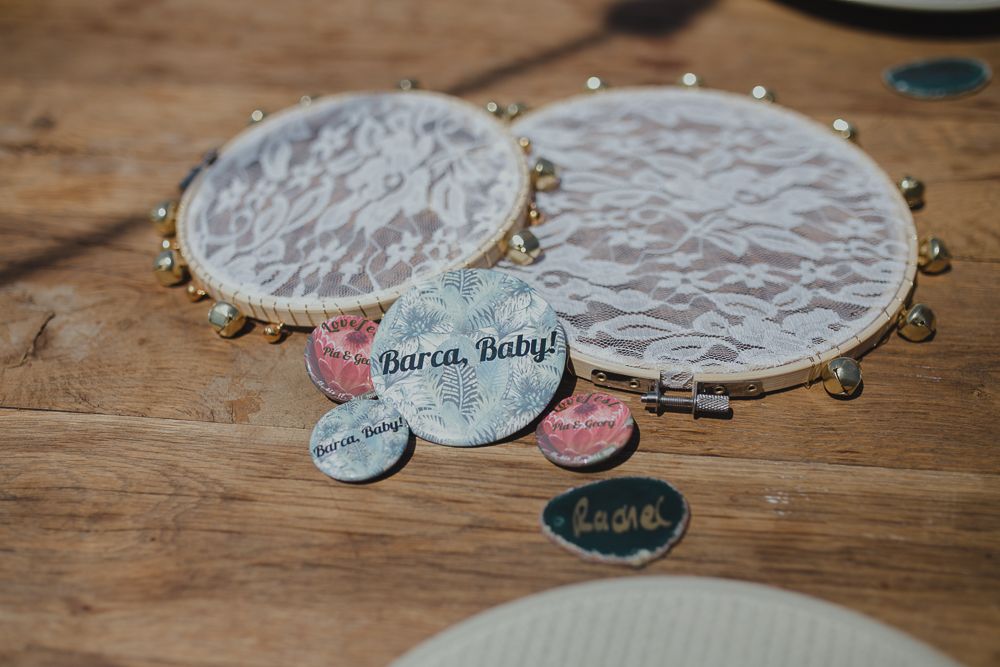 Decorative tambourines with personal messages and embellishments displayed on wooden surface.