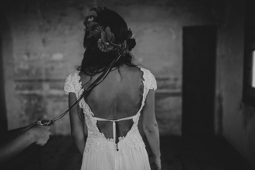 Back view of wedding dress showing detailed lace trim and open back design.