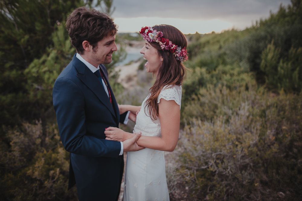A tender moment between newlyweds in a natural outdoor setting.