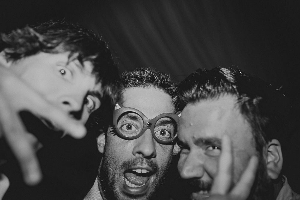 Close-up of guests making silly faces at wedding party celebration.