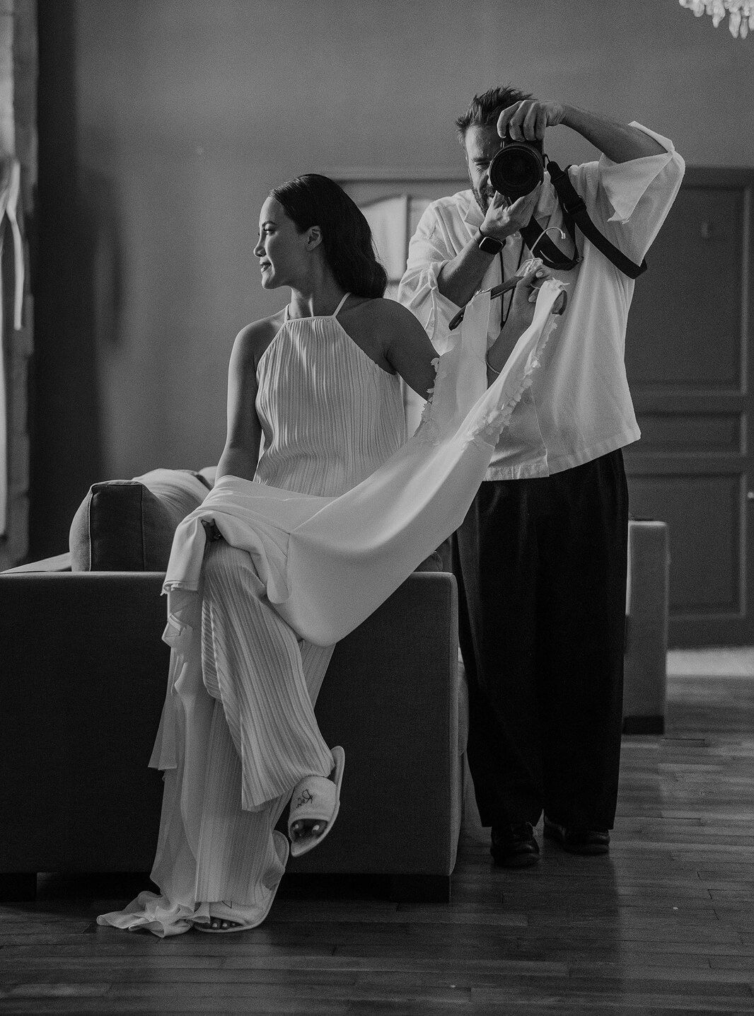 Black and white sequence of dancers performing elegant movements in flowing white dresses.