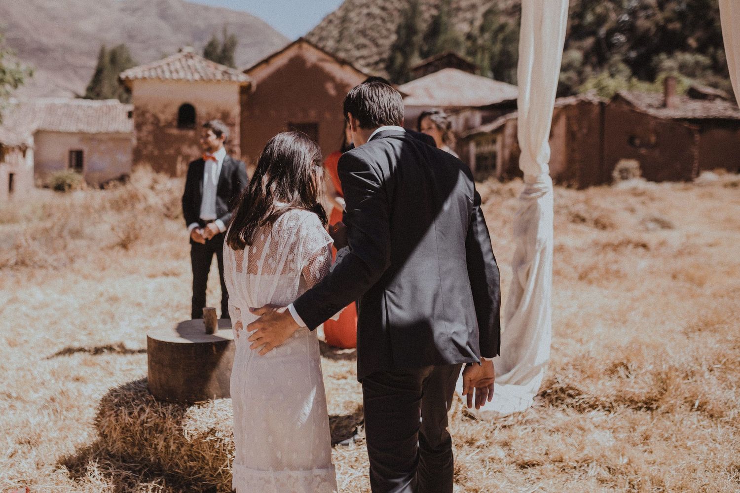 A couple shares an intimate moment during their desert wedding ceremony.