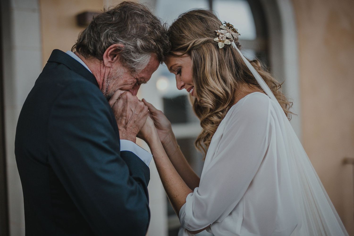 Emotional moment between bride and loved one during wedding ceremony.