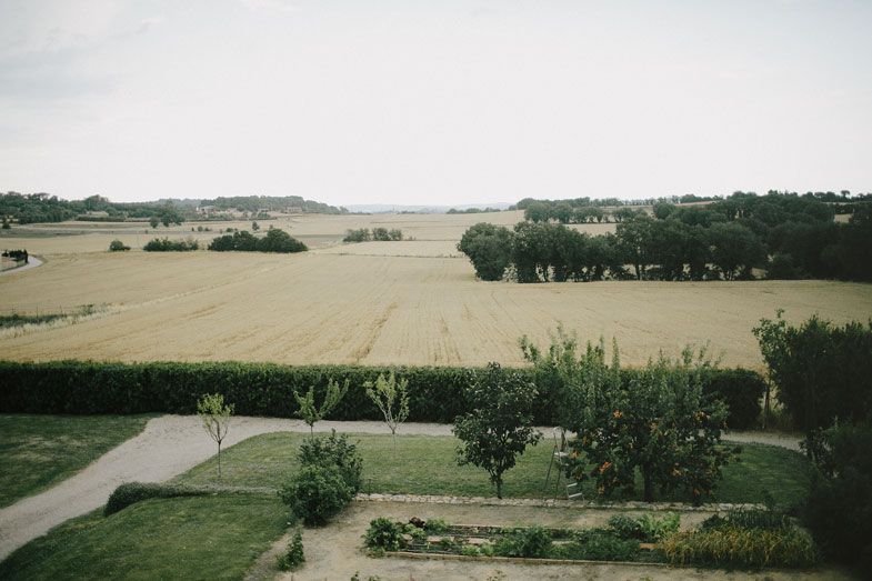 Rural landscape view with fields and trees stretching to the horizon.