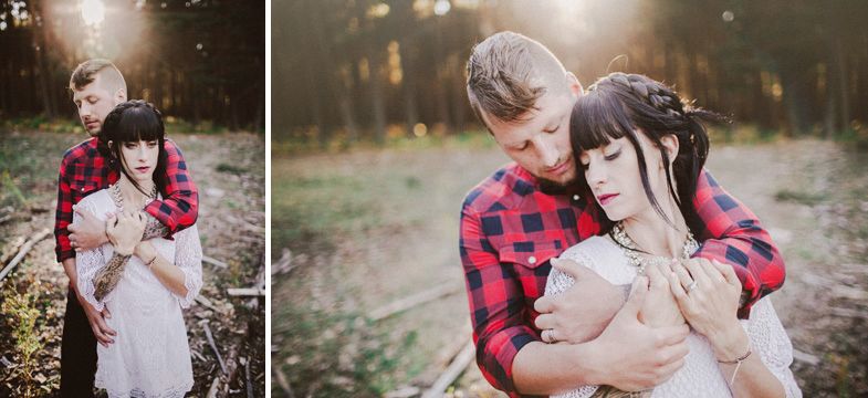 Couple in rustic attire sharing intimate moments in a forest setting.