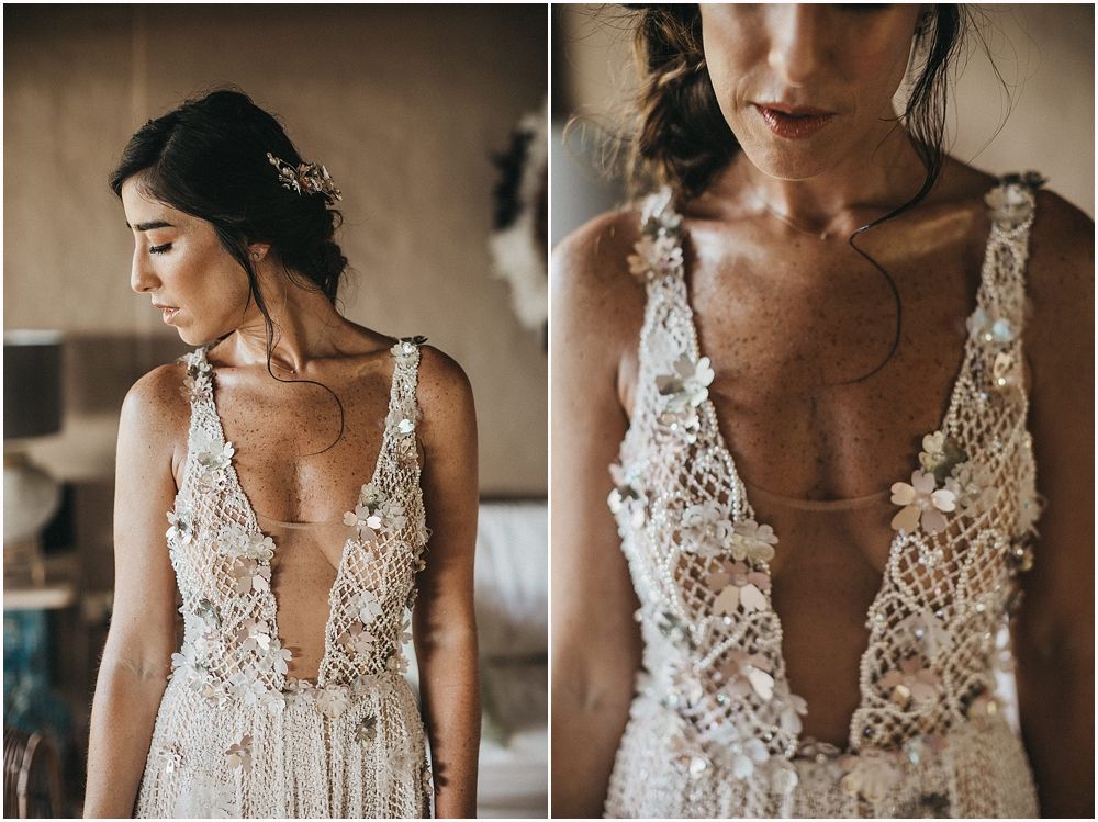 A close-up detail of a plunging V-neck wedding dress with intricate lace appliques.