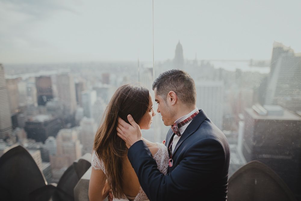 A romantic moment between newlyweds overlooking the New York City skyline.