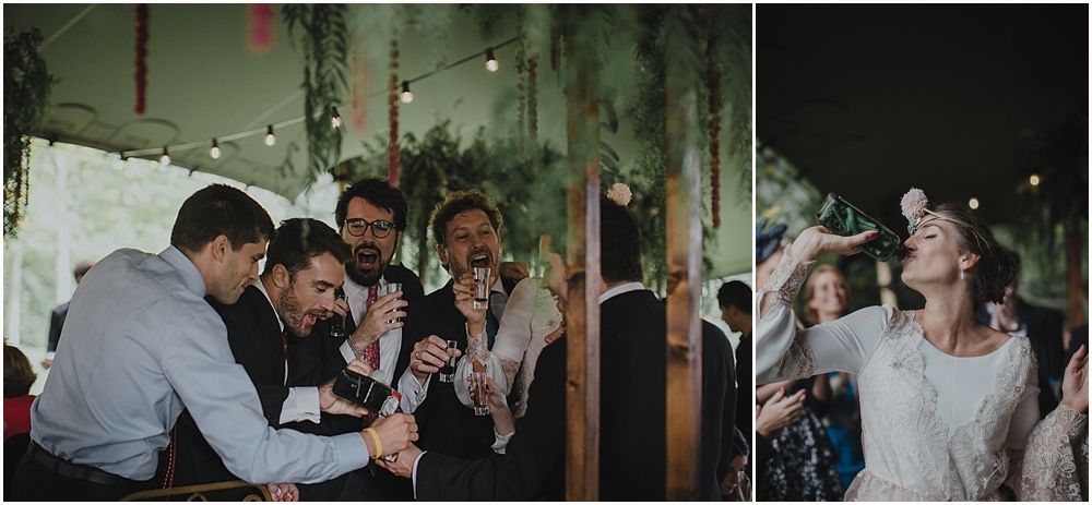 Party guests sharing laughter and drinks at an evening celebration with string lights overhead.