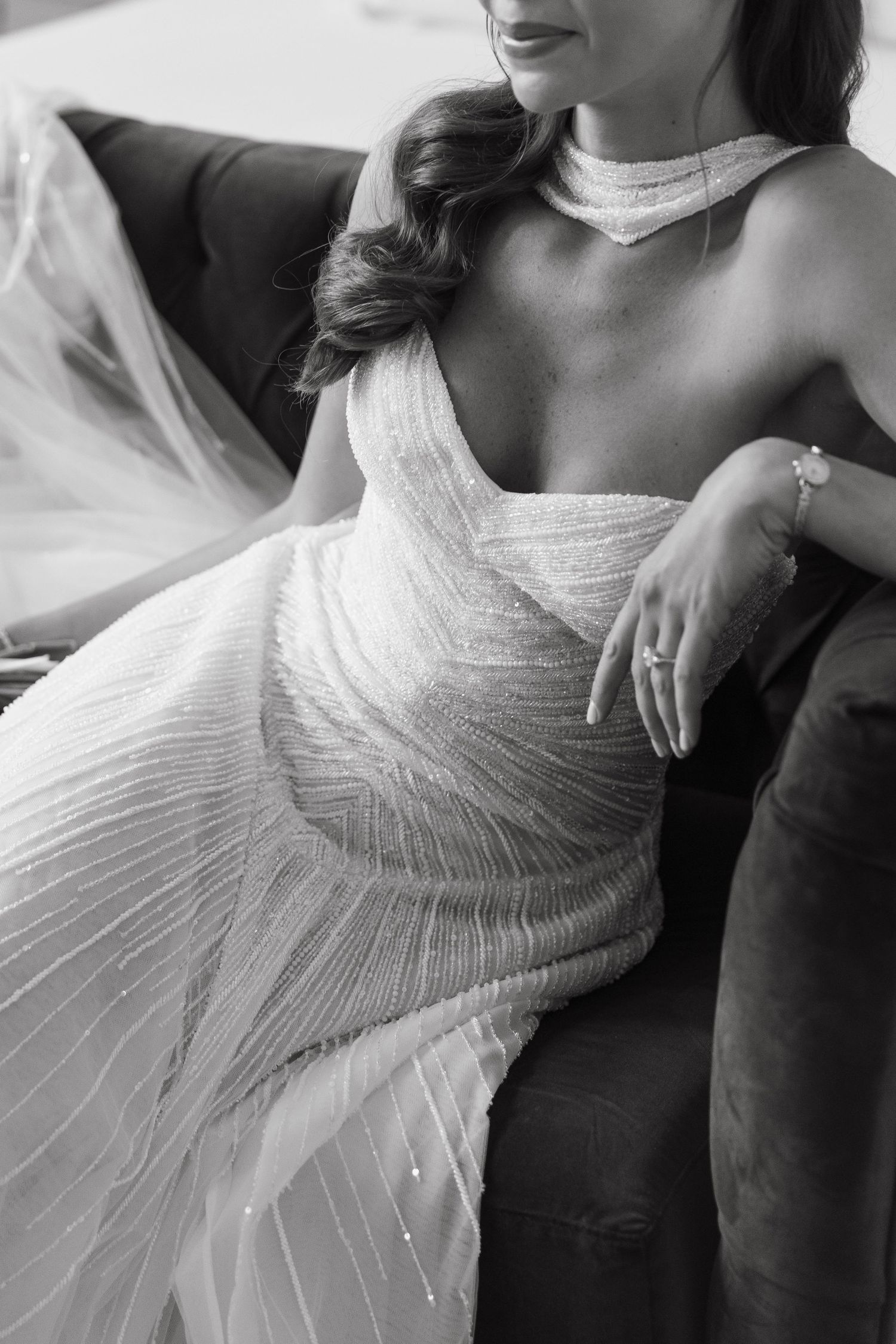 Close-up details of an intricately pleated white wedding dress bodice.