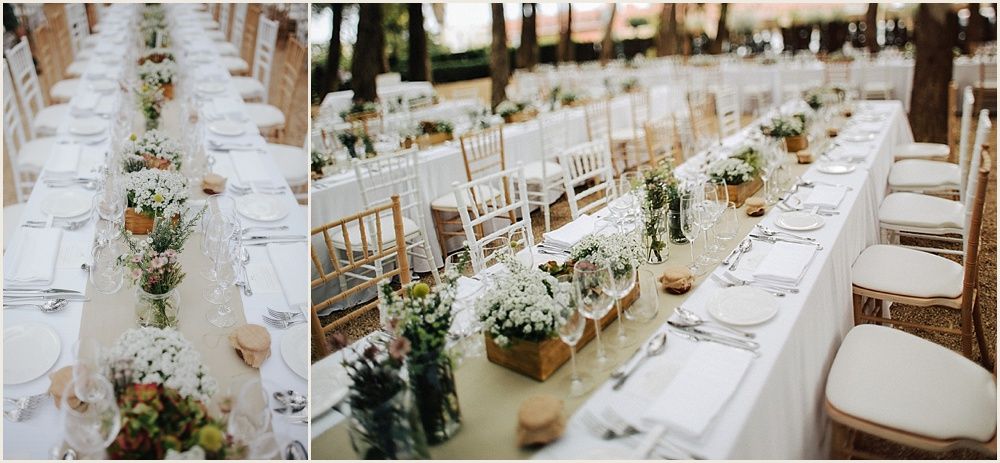 Elegant wedding reception table setting with white linens and floral centerpieces.