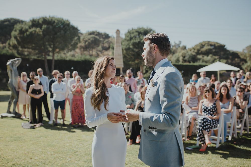 Couple dances together during their outdoor wedding celebration with guests watching.