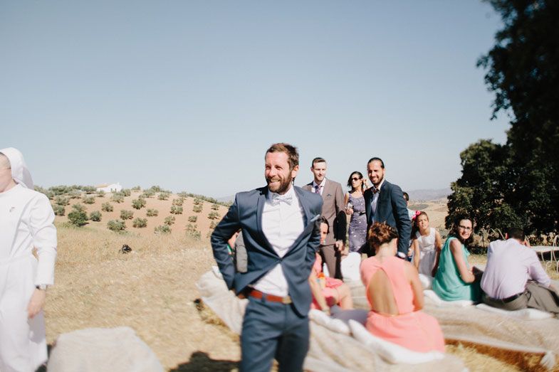 A casual moment under tree shade in a rustic Mediterranean setting.