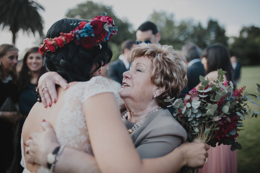 A heartfelt hug shared during wedding celebrations on a sunny afternoon.